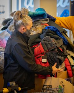 woman inspecting coats