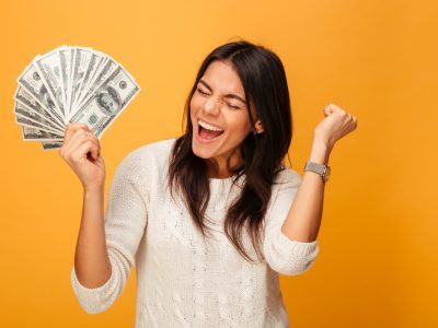 happy woman with money in hand