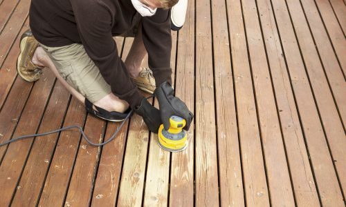 worker sanding deck