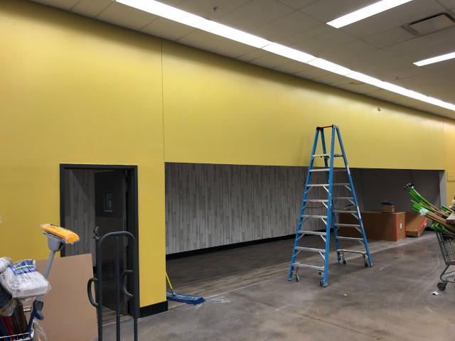 urban hardware stores after being repainted - yellow wall