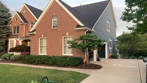 brick and siding home exterior painted with trim as well