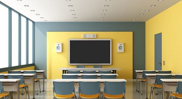 Classroom with tables chairs and yellow walls