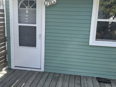 door with teal painted home siding