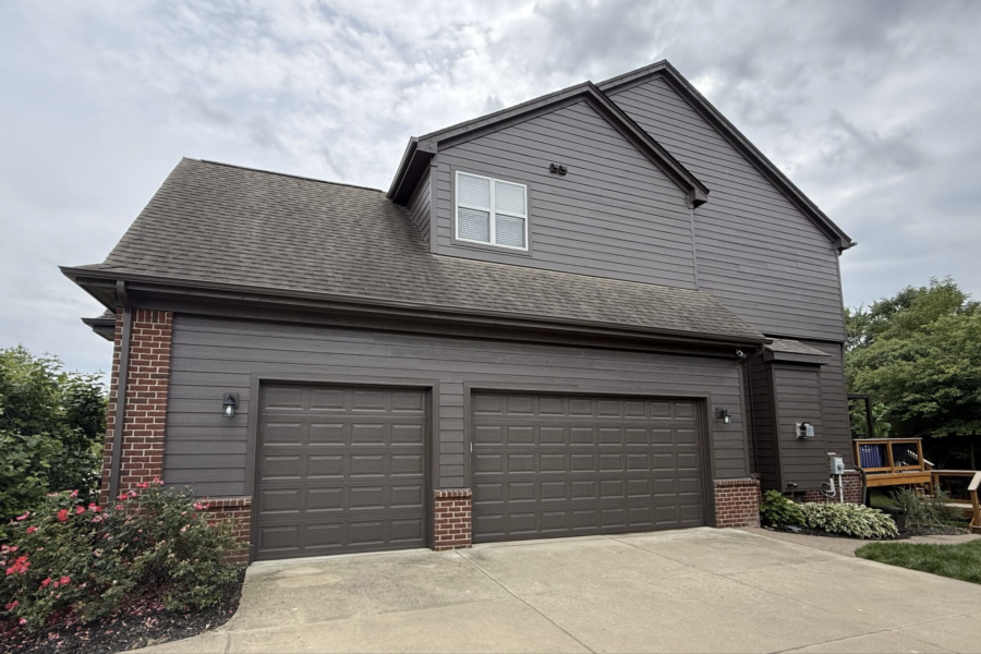 garage side of house with brick and dark grey painted siding Preview Image 1