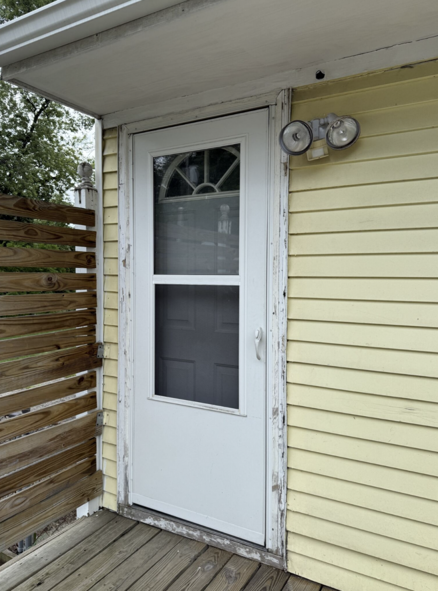 door and worn yellow siding of house Preview Image 1