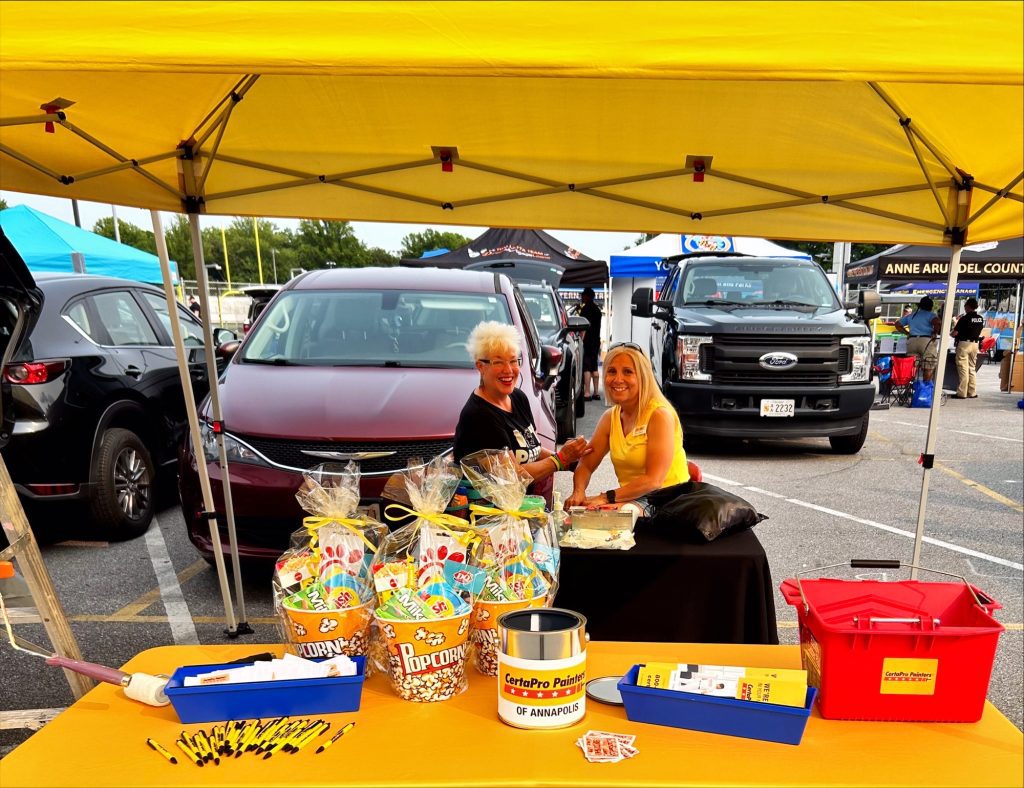 Monica sitting behind her table at the 2023 National Night Out