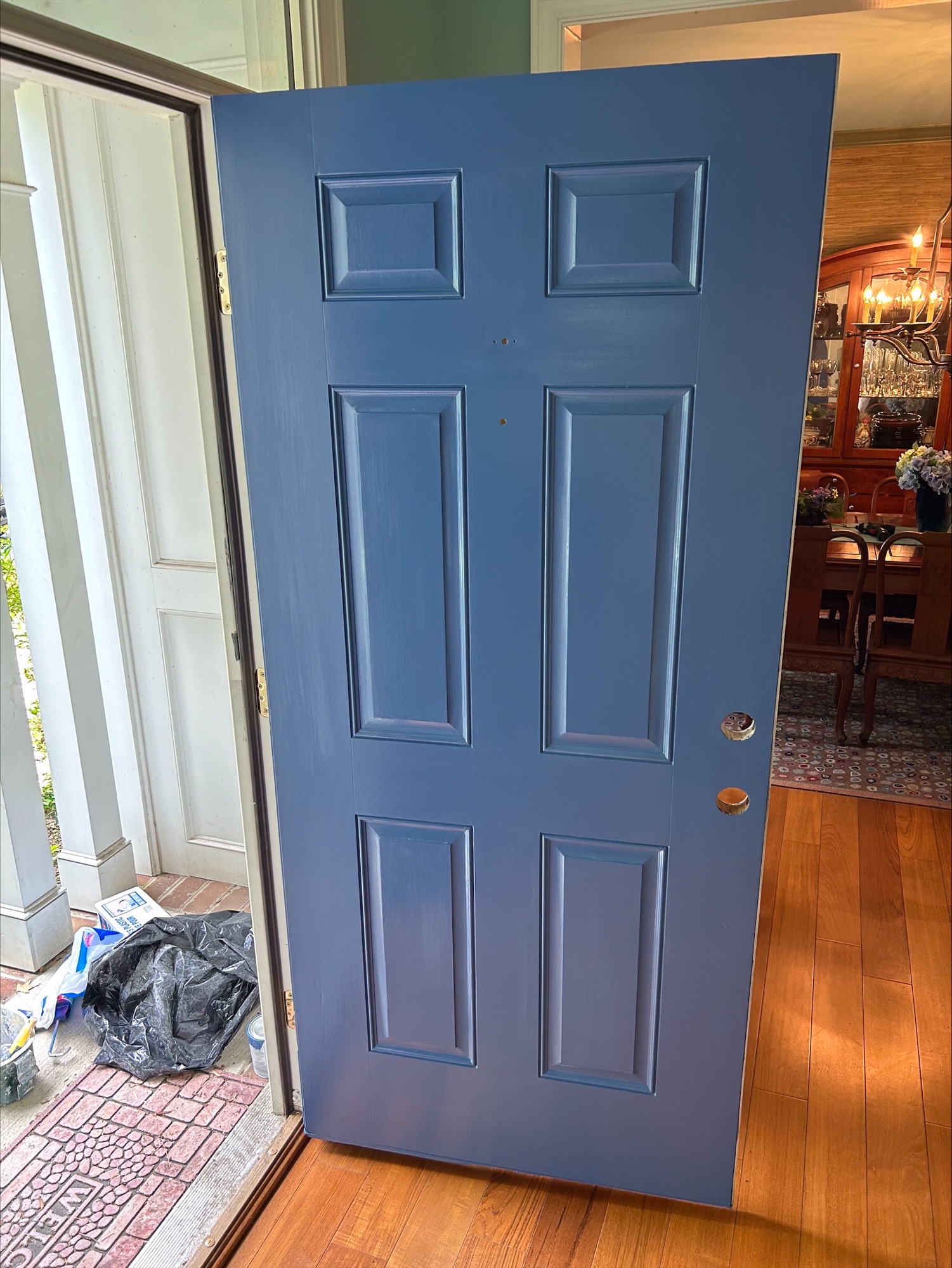 indoor front view - newly painted open blue door after photos exterior painting project by certapro painters of annapolis