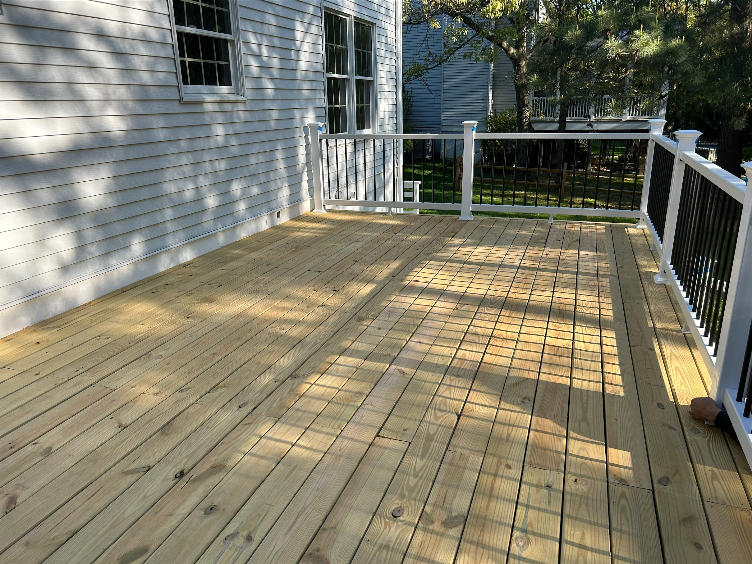 Deck in arnold, md, with fresh wood before staining and sealing by certapro painters of annapolis
