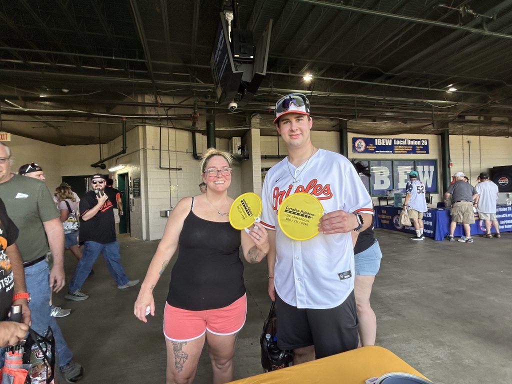 baseball fans holding certapro annapolis hand fans