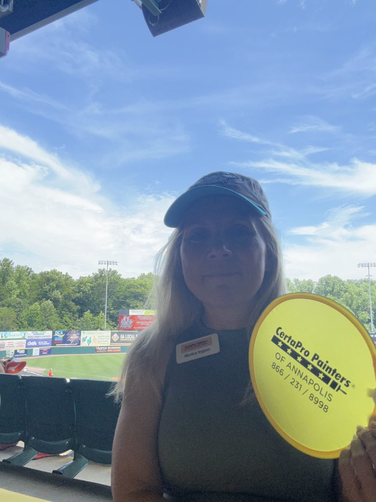 Monica holding certapro painters fan