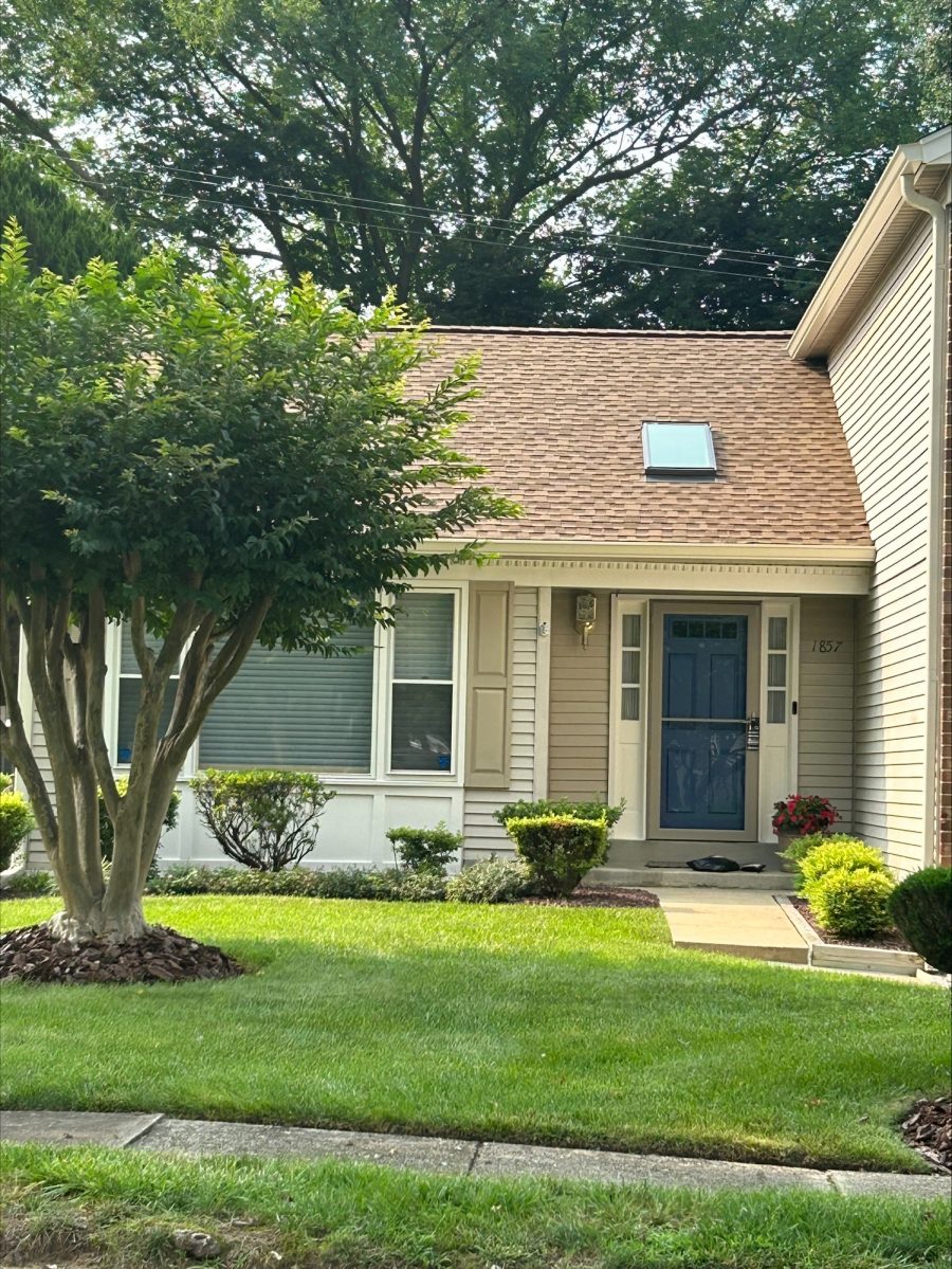 Front View of Beige house with blue door in Crofton, MD after completed painting project by CertaPro Painters of Annapolis Preview Image 2
