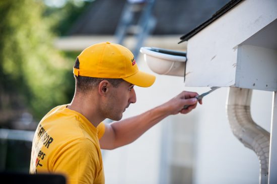 CertaPro Team Member working on a home exterior