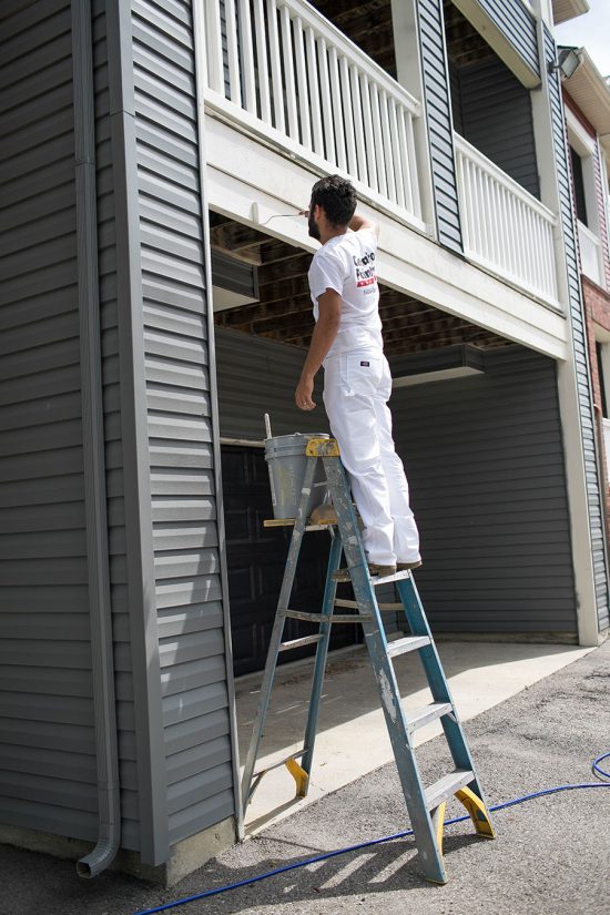 worker painting exterior