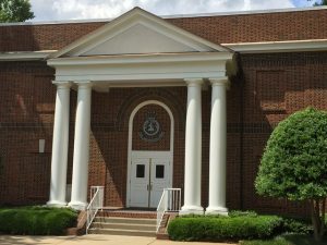 Painted Brick Home With White Pillar Entrance