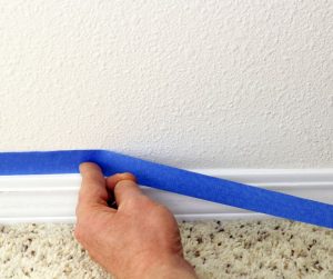 masking trim along wall for painting