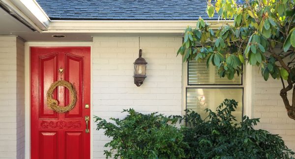 brick house painted white with red front door