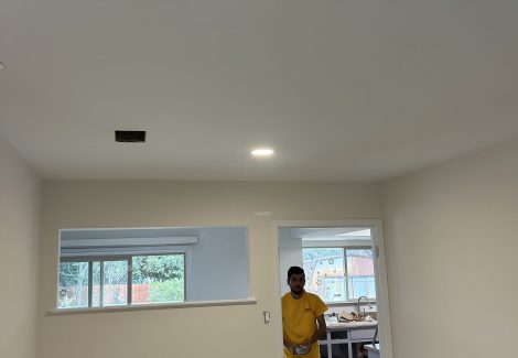 painter in white painted interior room
