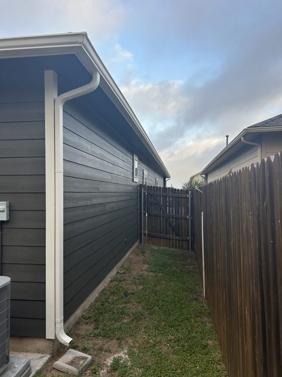 side of house with charcoal painted siding and wooden fence Preview Image 10