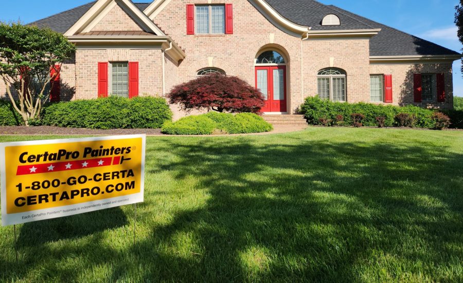 brick exterior of home in maryland with red shutters
