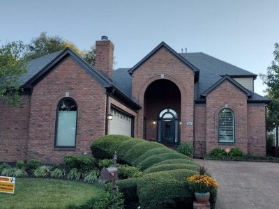 brick home with dark painted trim