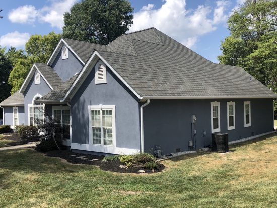House with Blue Stucco Exterior after completed stucco painting project by CertaPro Belleville