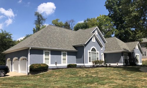 House with Blue Stucco Exterior after completed stucco painting project by CertaPro Belleville - Angle 2