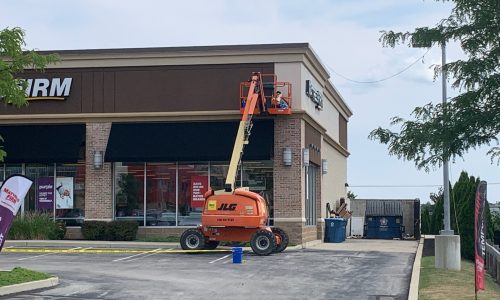Large Retail Building Painting With a Crane