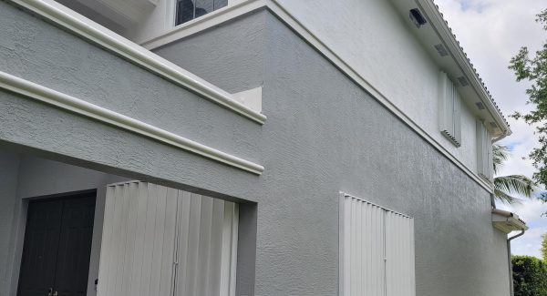 newly painted accordion shutters on exterior of house