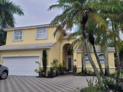 exterior of a house in boca raton, fl painted yellow