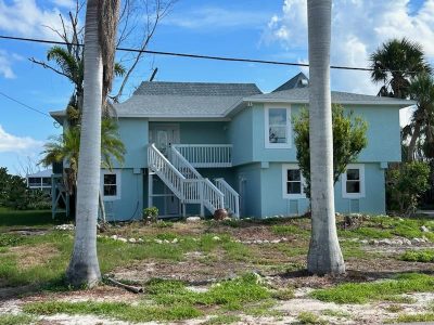 after photo of painted house exterior blue and white