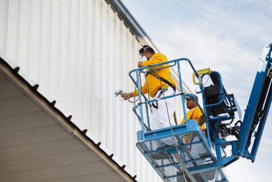 commercial painters spray painting warehouse exterior