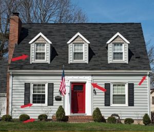Gray cape home with arrows showing areas of wood rot
