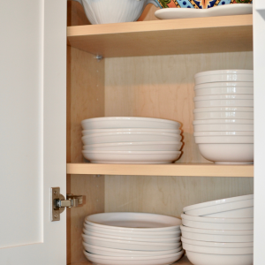 unpainted shelving inside white kitchen cabinet