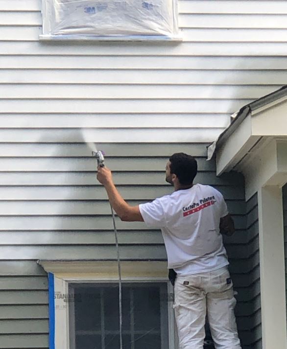 painting siding on a home in boston