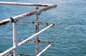 Rusty railing over the ocean