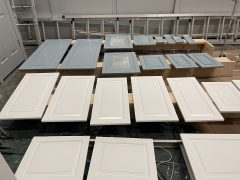 Kitchen cabinet doors drying after being painted white and gray-blue