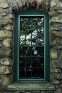 Green door in rock house