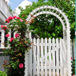White arbor with pink roses