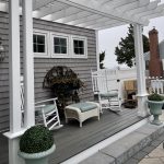 Gray house and porch with white pergola
