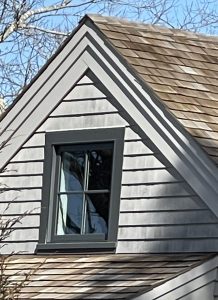 Gray shingles near roof and black window