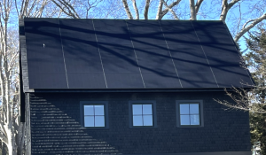 Dark brown barn with dark solar panels