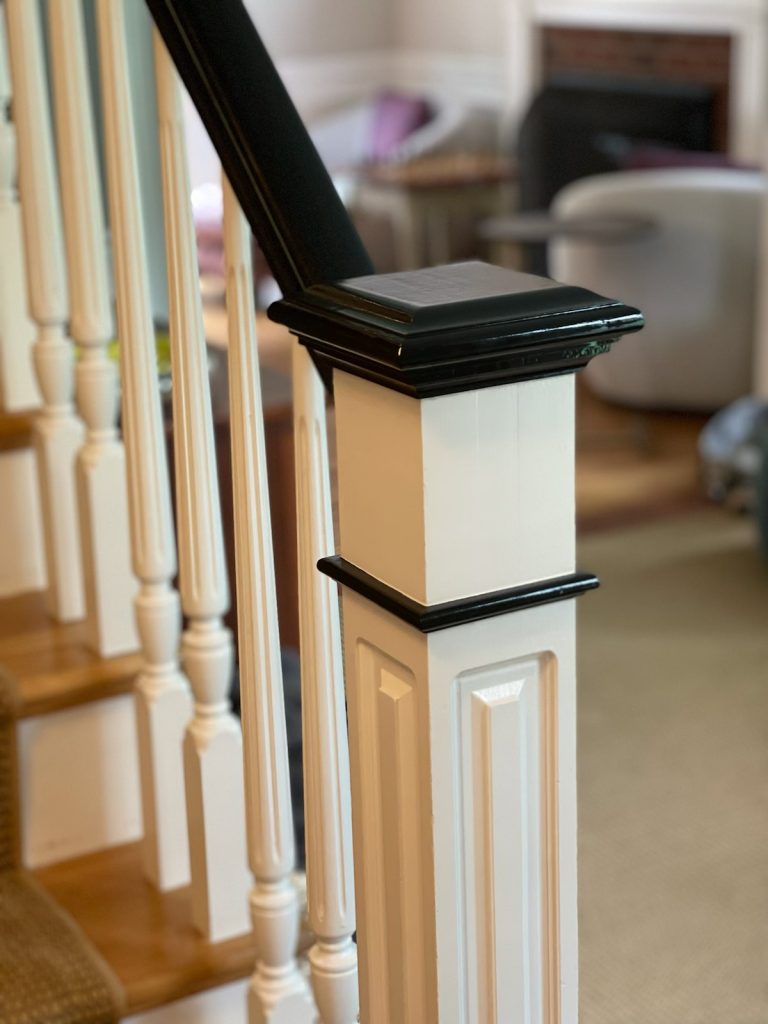 Black and white staircase banister and spindles