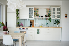 White kitchen cabinets with light blue backsplash