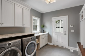 Gray walls with white cabinets in a laundry room