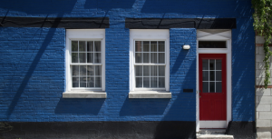 Blue brick home with red door