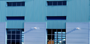 Turquoise and light blue corrugated metal panel siding on commercial building