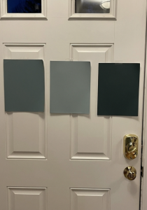White door with three large paint samples taped to it
