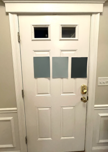 Door with three paper paint samples taped to it