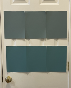 3 large paint chips in 2 different colors of green are taped together to form 2 giant paint sample chips