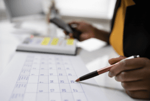 Photos of a hand holding a pen pointing to a calendar on the desk